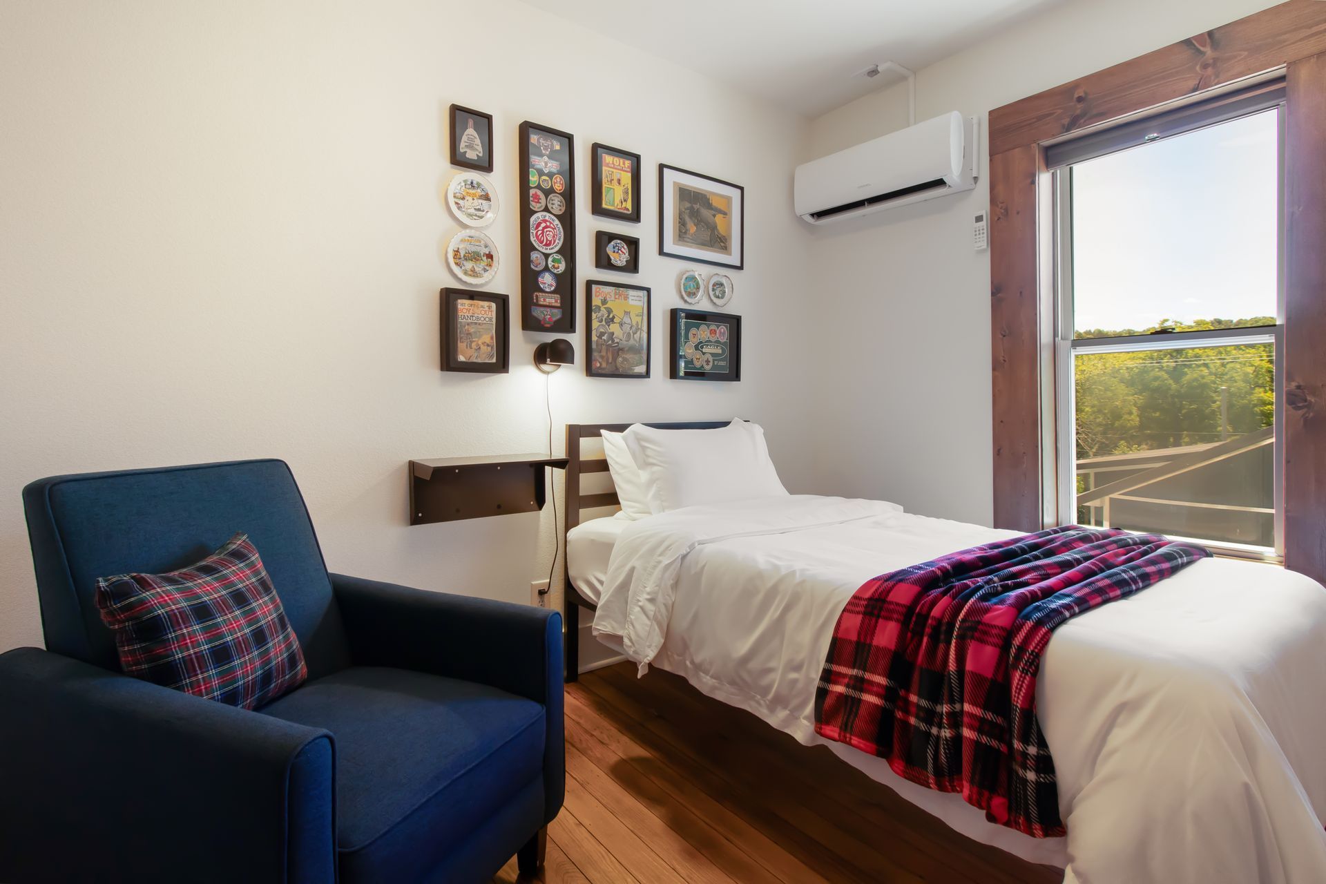 A bedroom with a bed , chair , and window.