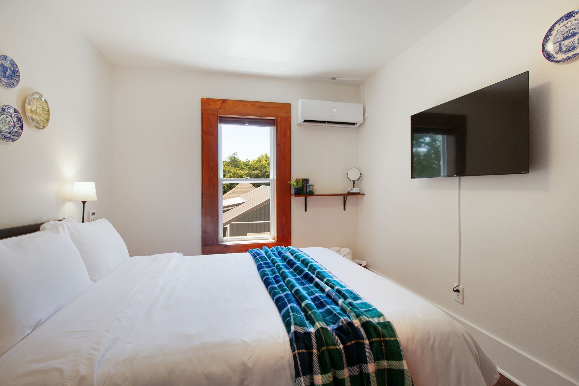 A bedroom with a king size bed and a flat screen tv