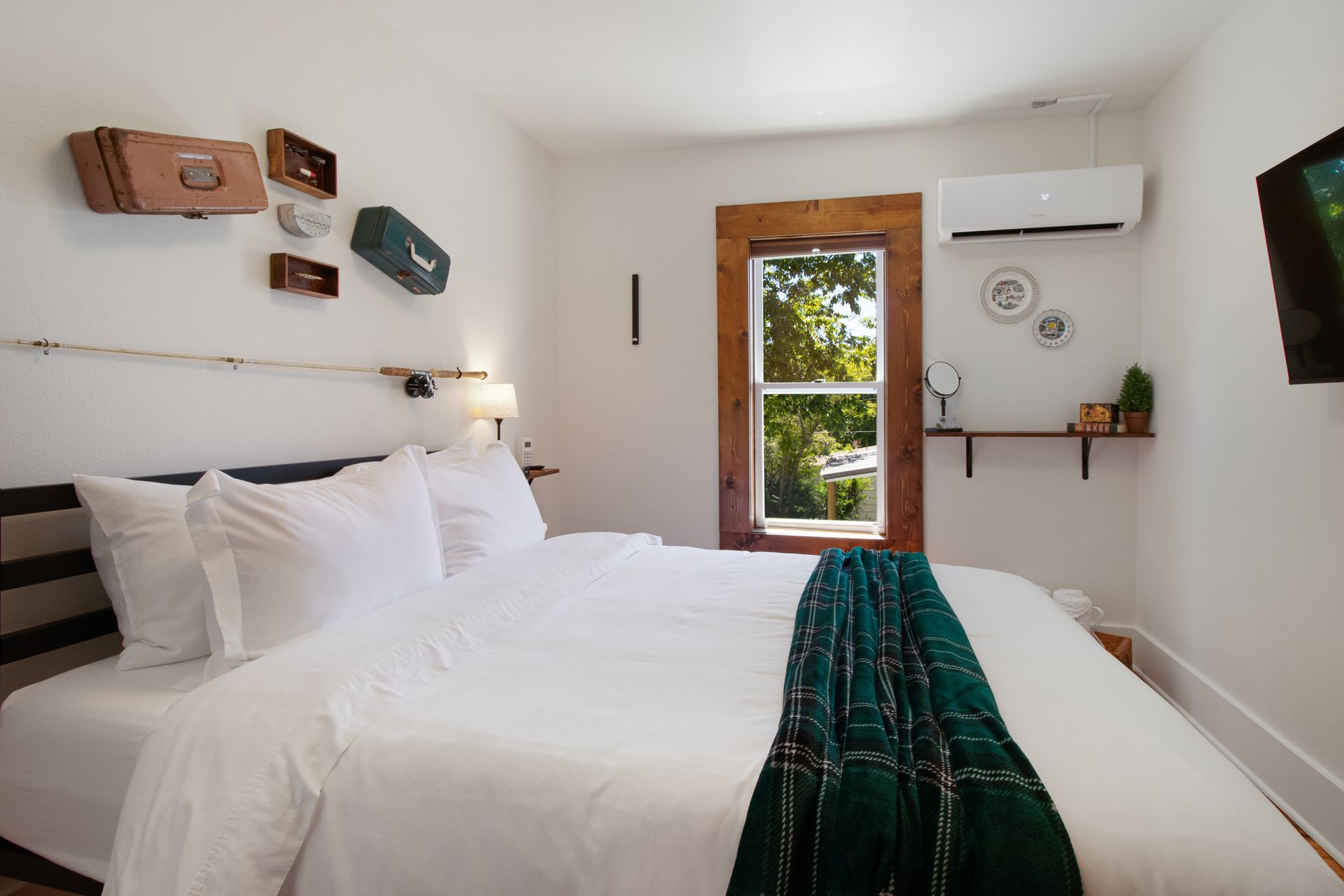 A bedroom with a large bed and a window.