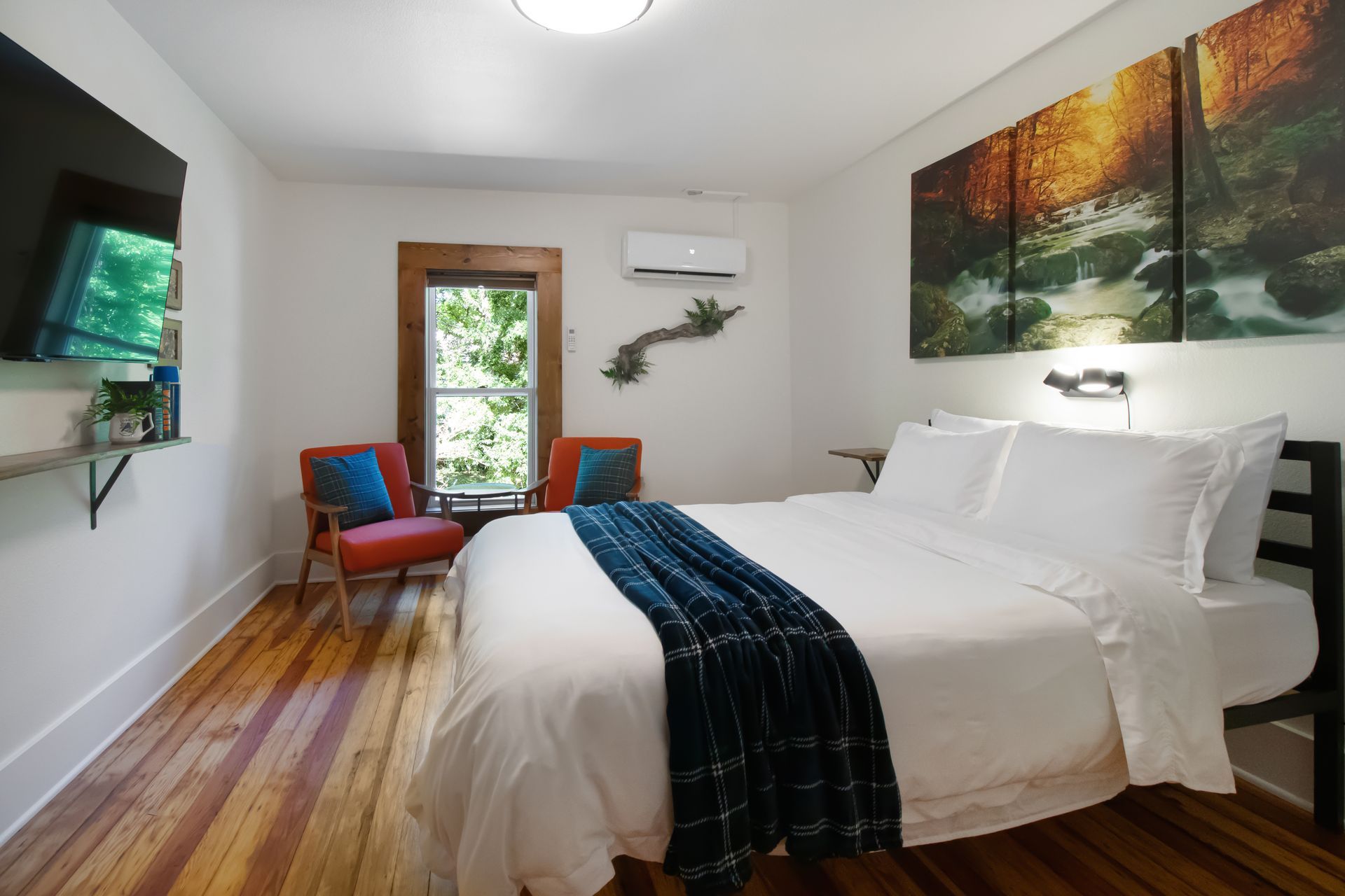 A bedroom with a king size bed and two chairs