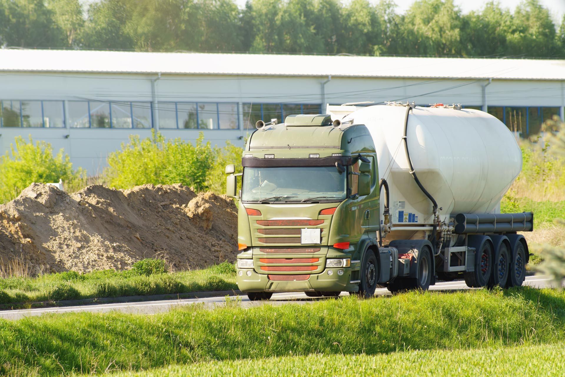 Large gas tanker truck traveling through industrial. Large gas tanker truck traveling through industrial.