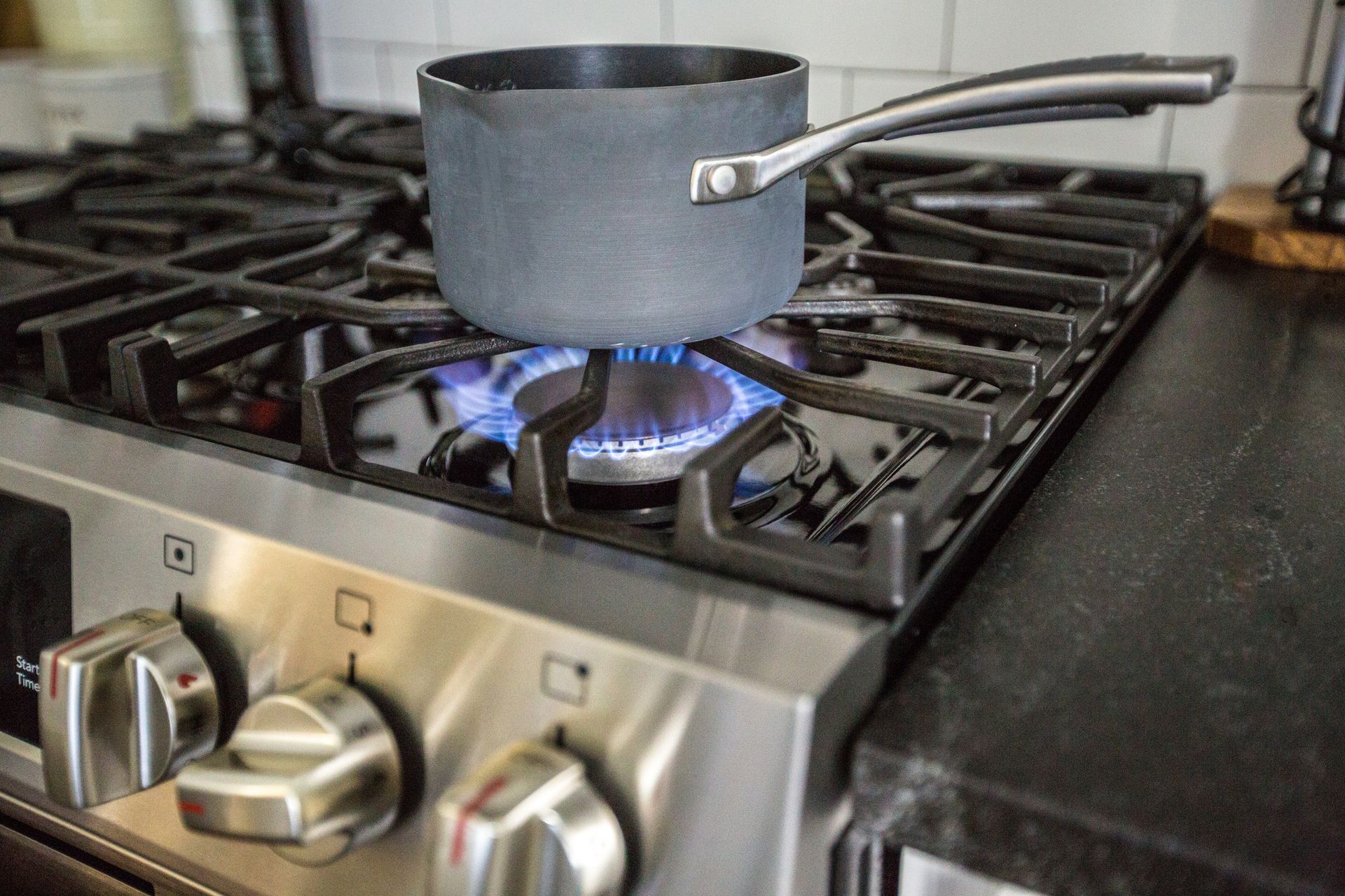 A stainless-steel pot on a gas stove. A stainless-steel pot on a gas stove.