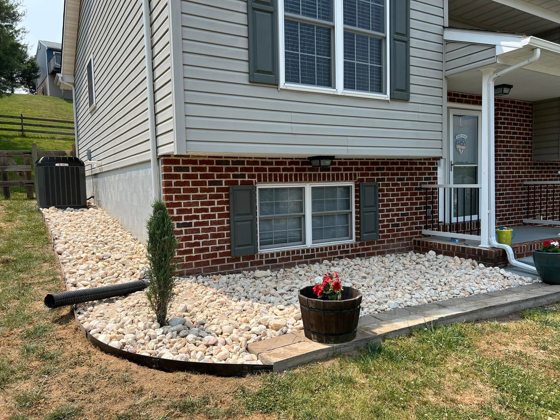 A brick house with a gravel walkway in front of it.