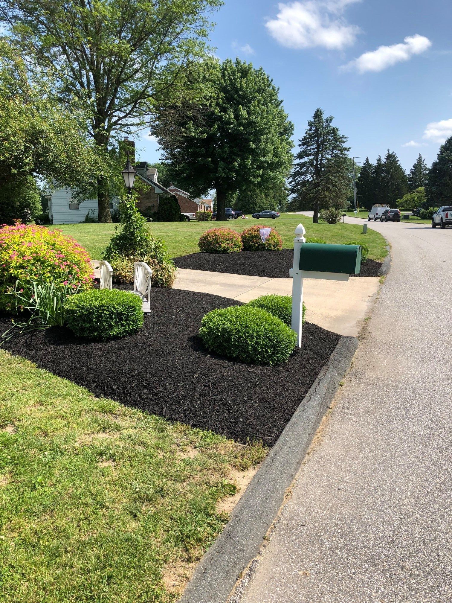 There is a mailbox on the side of the road.
