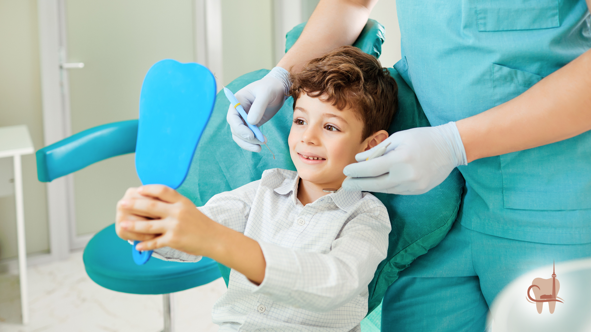 Boy in dentist chair looking at mirror, dentist nearby.