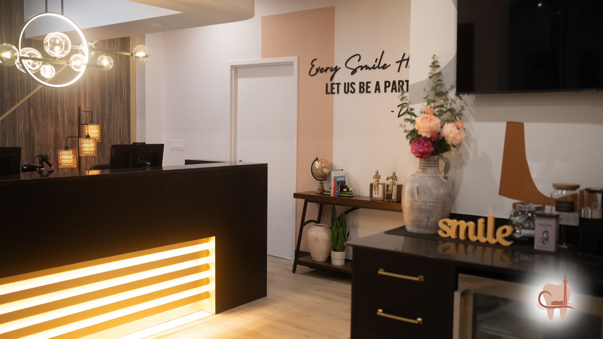Reception area with black desk, illuminated gold lines, and decorative accents; 