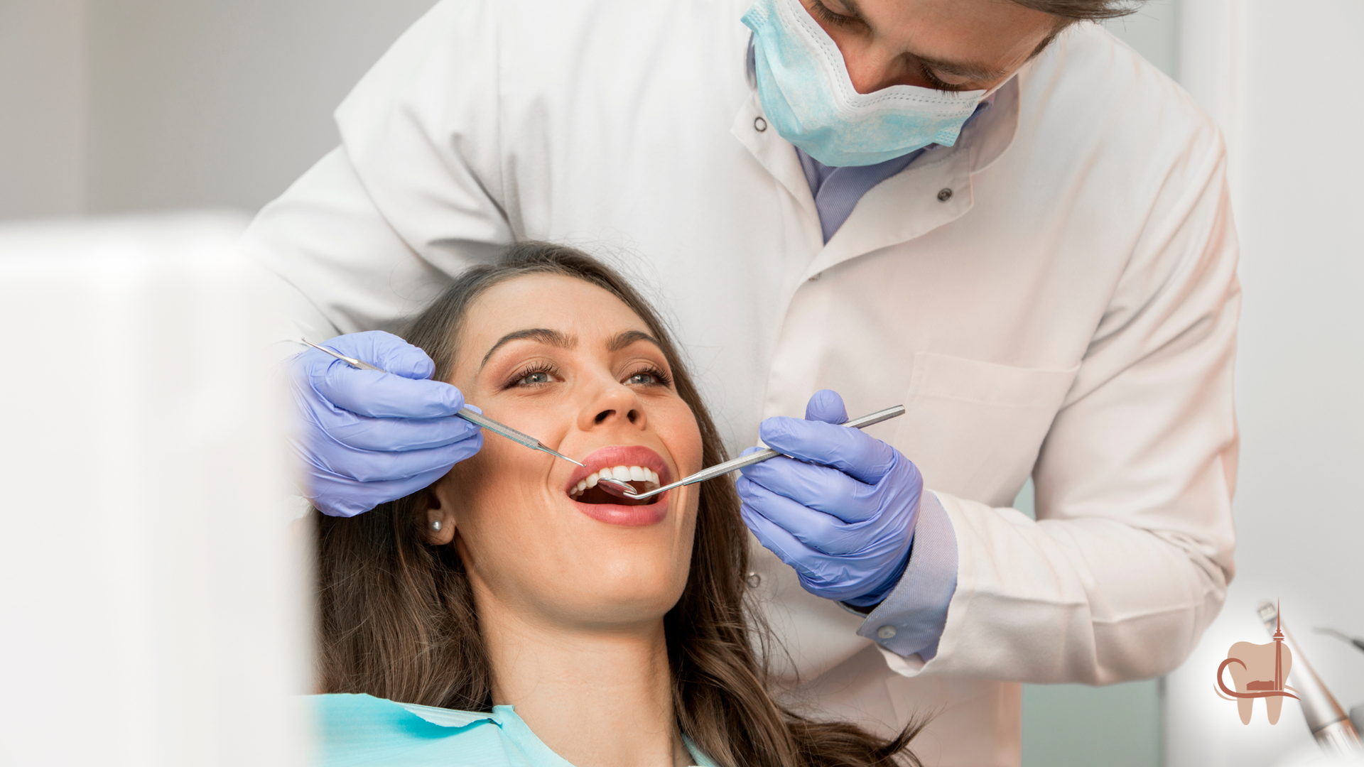 Dentist examining patient's teeth with tools in a dental office.