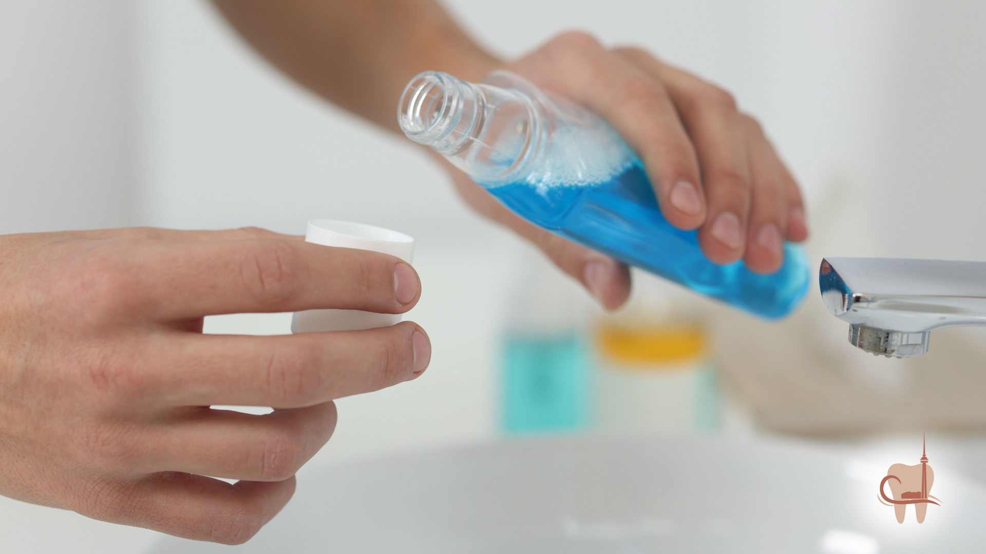 Person pouring blue mouthwash into a white cap in a bathroom.