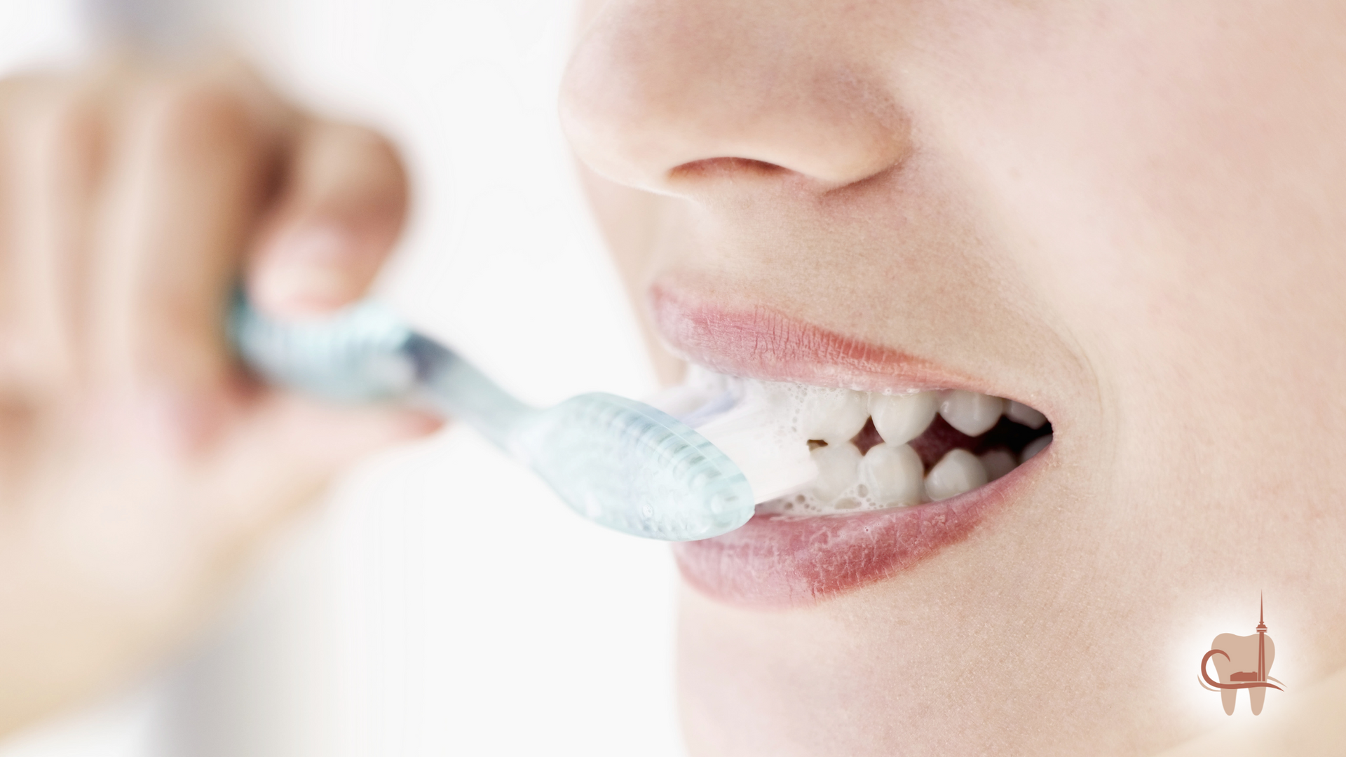 Person brushing their teeth with a foamy, blue toothbrush, focusing on upper teeth; close-up.
