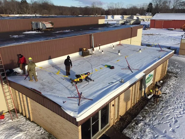 Men Installing Flat Roof – Jackson, MI – Billy White Roofing LLC