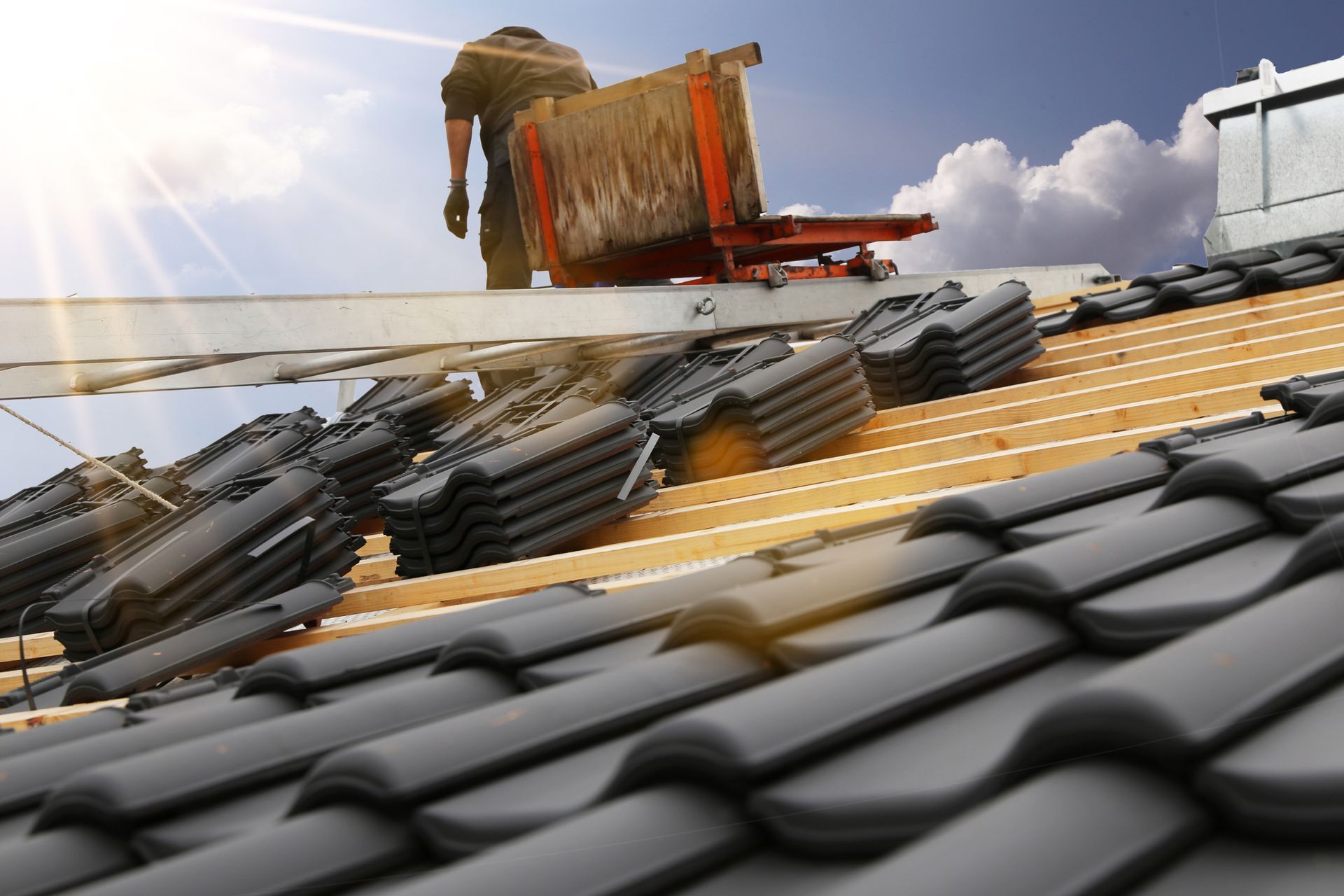 A person on a roof with a ladder in a Roofing Contractor