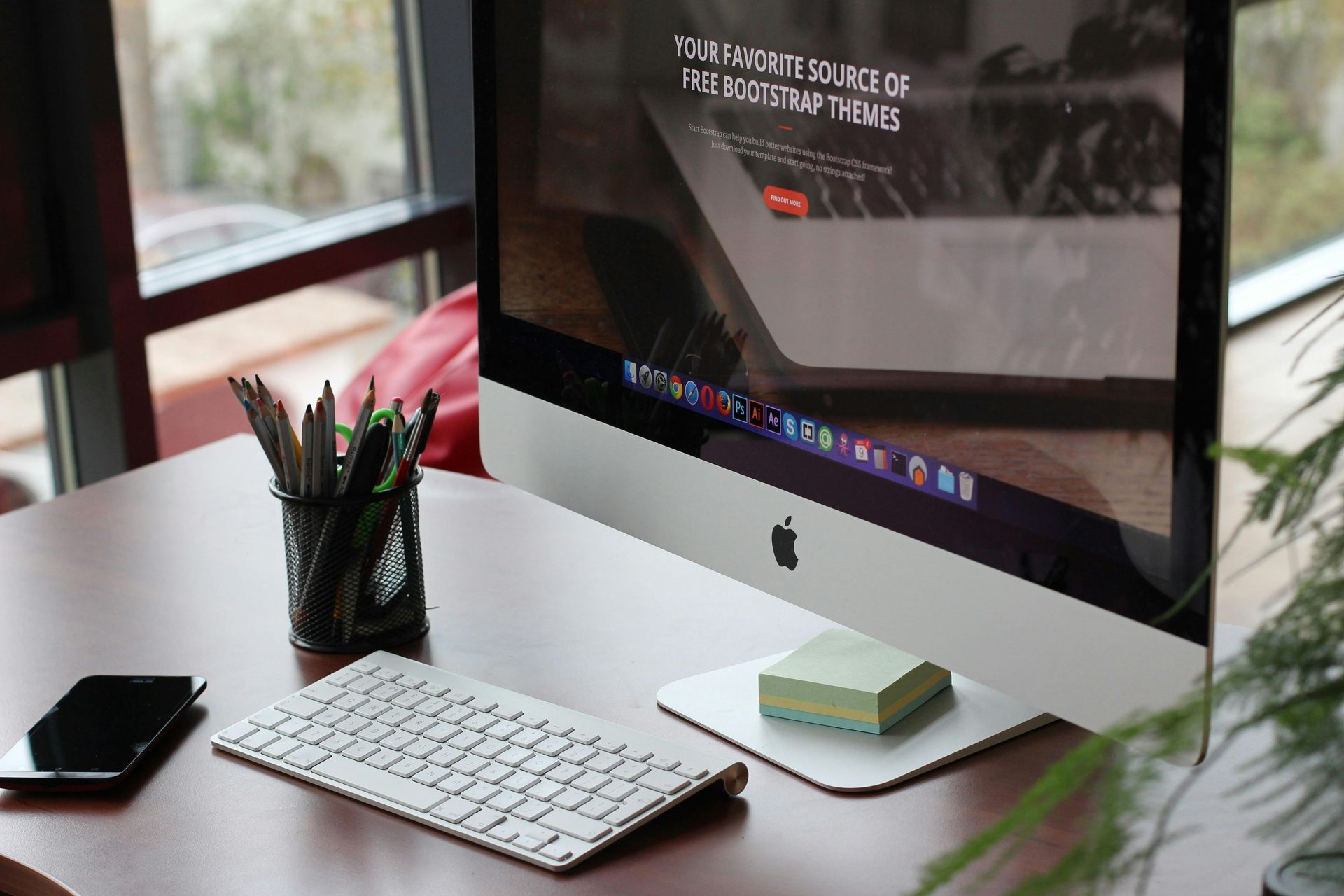 An apple computer is sitting on top of a wooden desk.