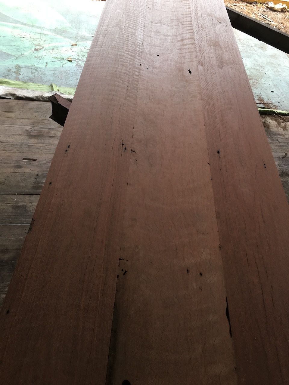 Close-up of a long, brown wooden plank with a weathered appearance.