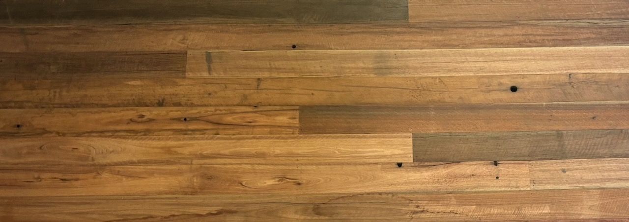 Wooden plank flooring, with variations in color and visible knots in Brisbane.