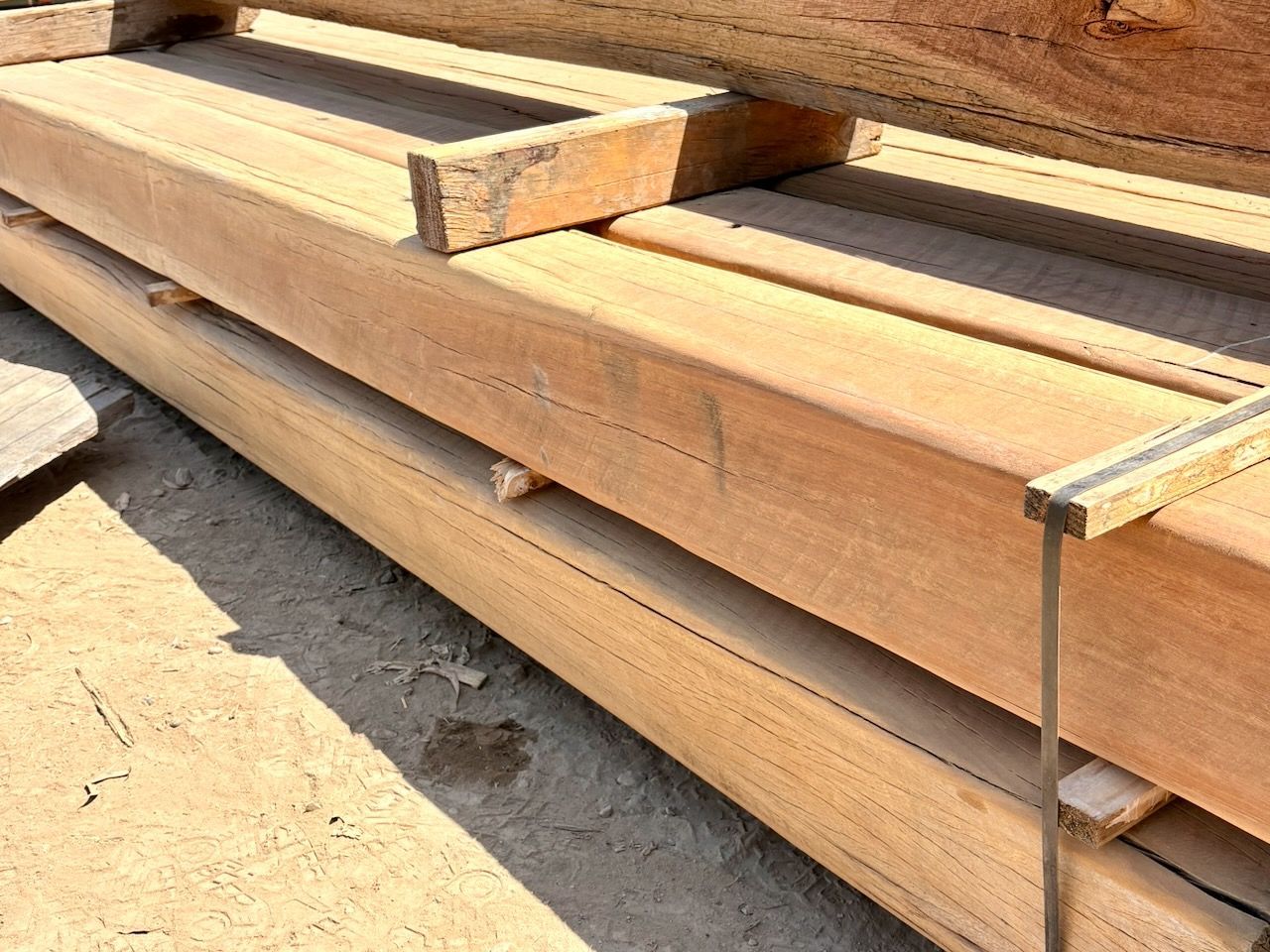 Stack of rectangular, light brown wooden beams.