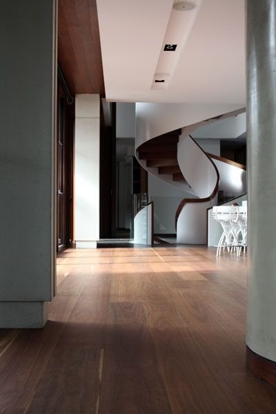 Interior view of a modern home with a wooden floor and a spiral staircase.