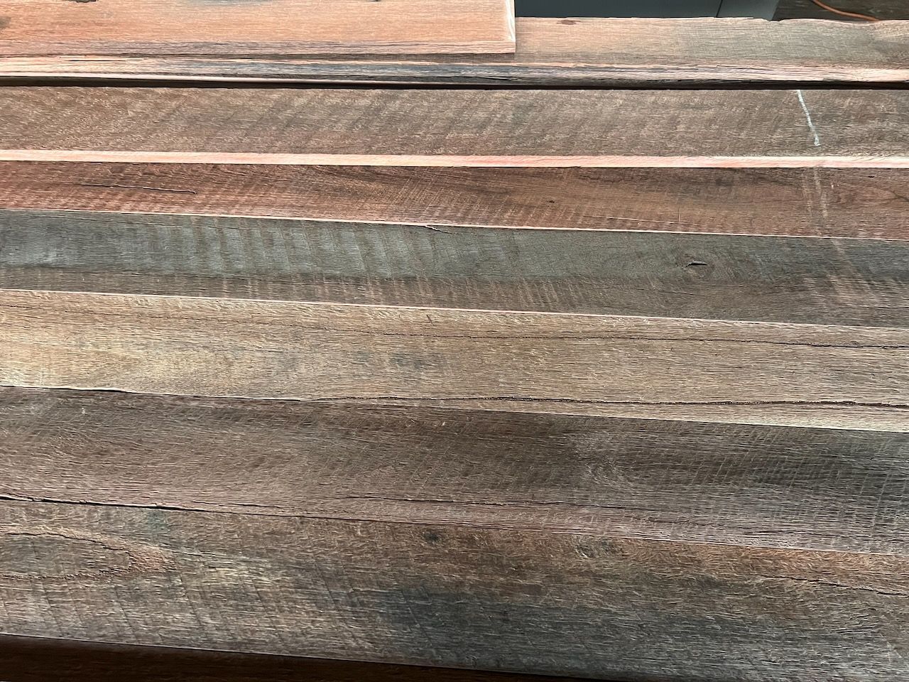 Weathered wooden planks in various shades of brown and gray in Brisbane.