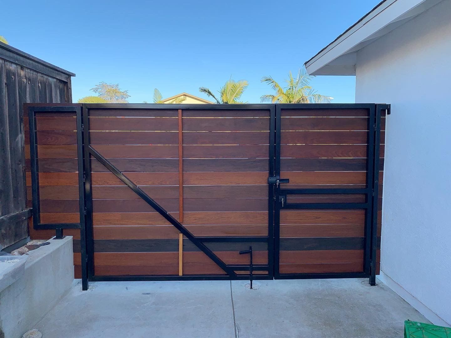 A wooden gate is sitting in front of a house.