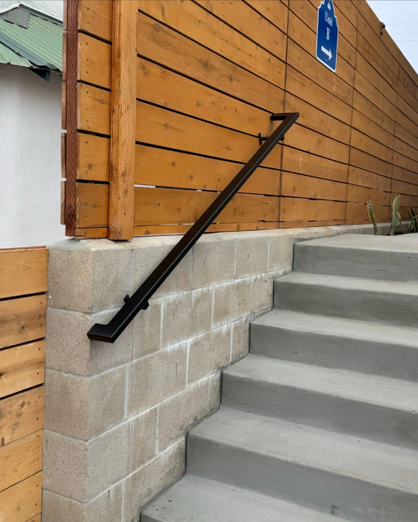 A set of stairs with a wooden fence behind them