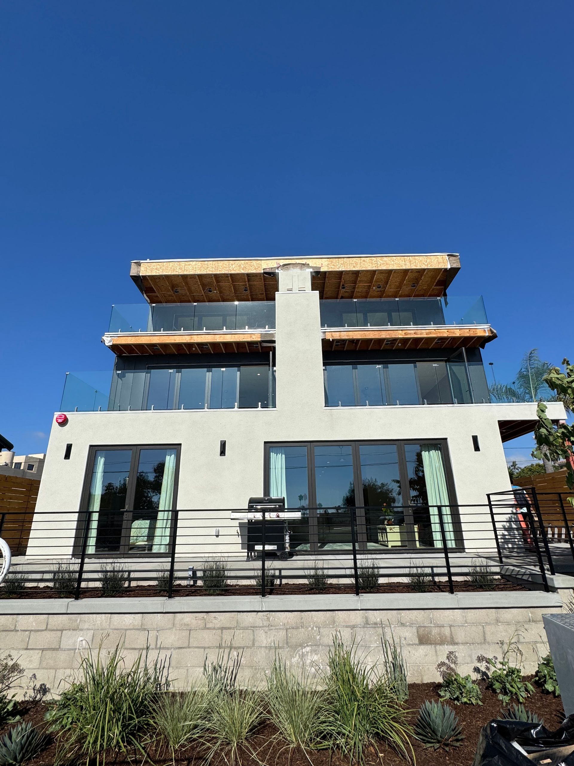 A large white house with a lot of windows and balconies.