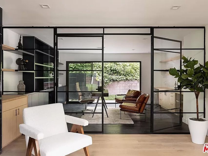A living room with sliding glass doors and a chair.