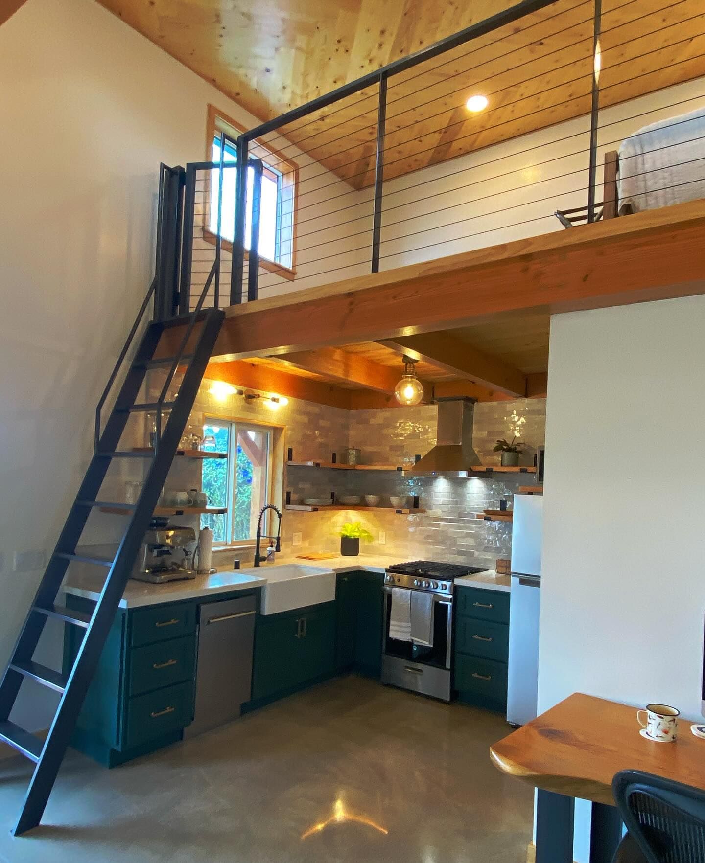 A kitchen with a staircase leading up to the second floor