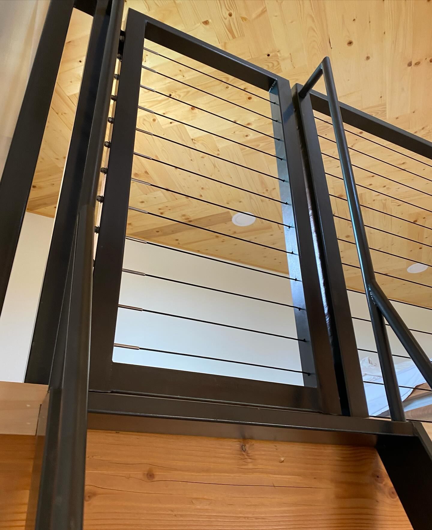 A close up of a staircase with a wire railing