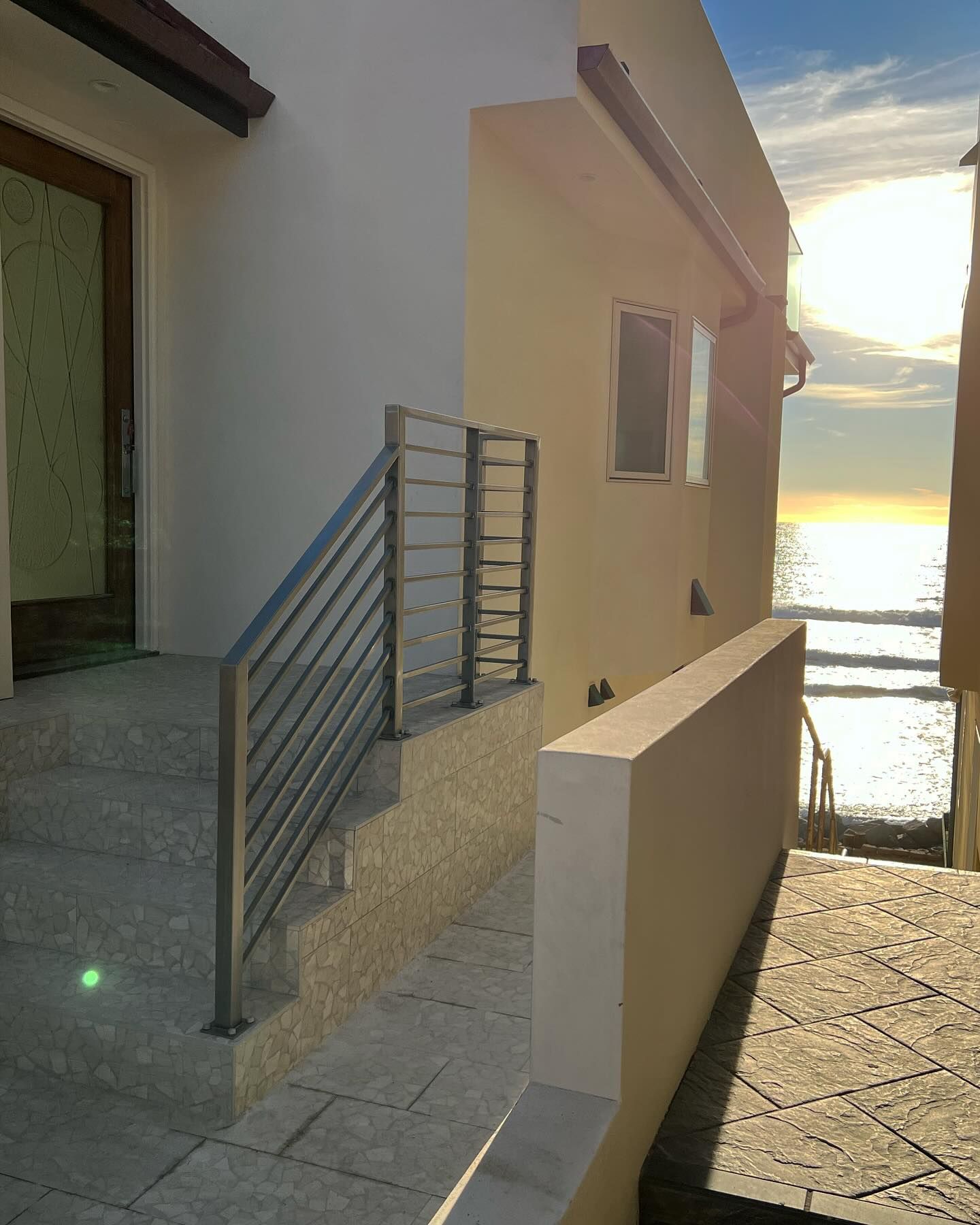 A building with stairs leading up to the ocean