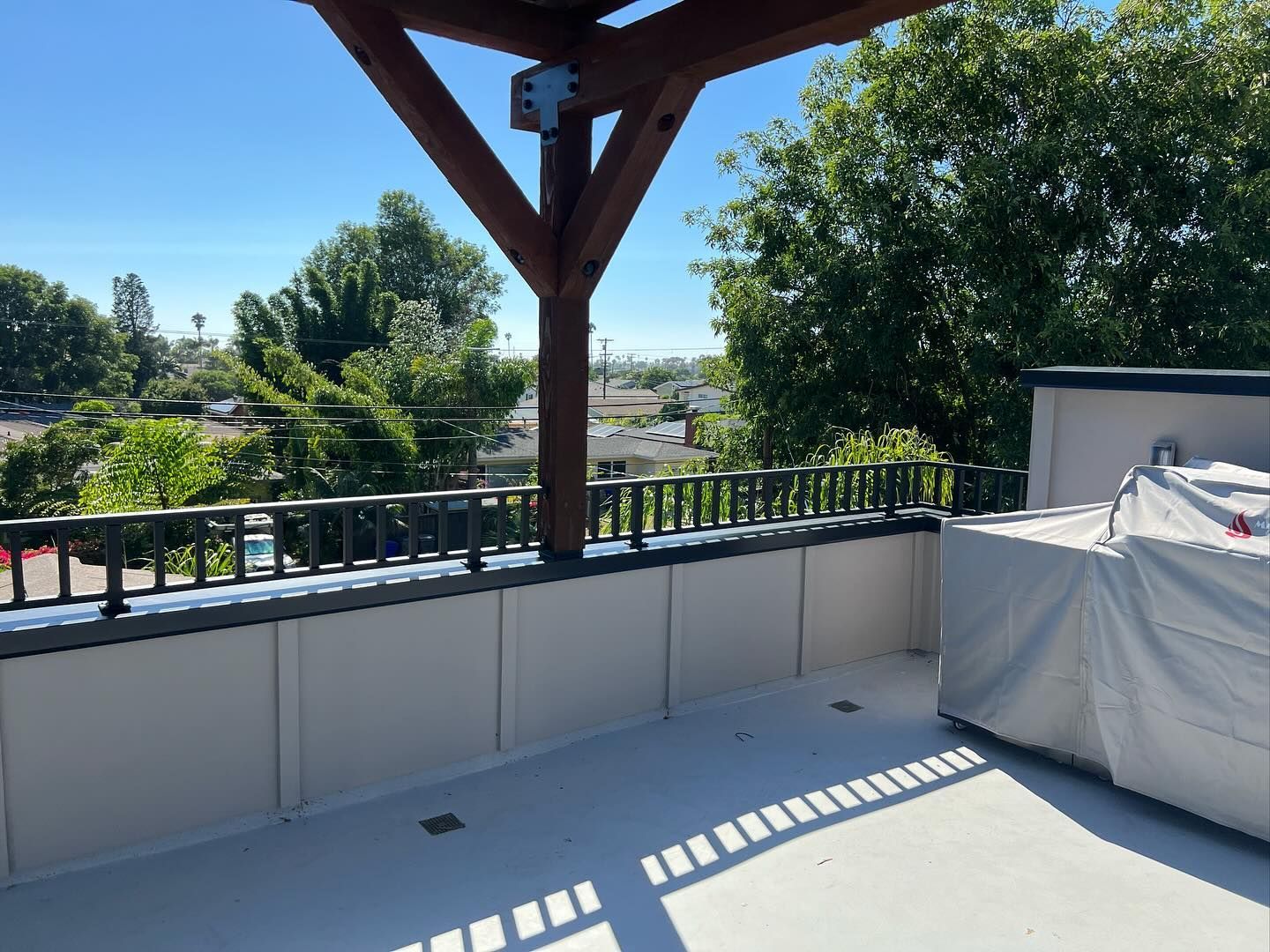 A balcony with a view of a city and trees