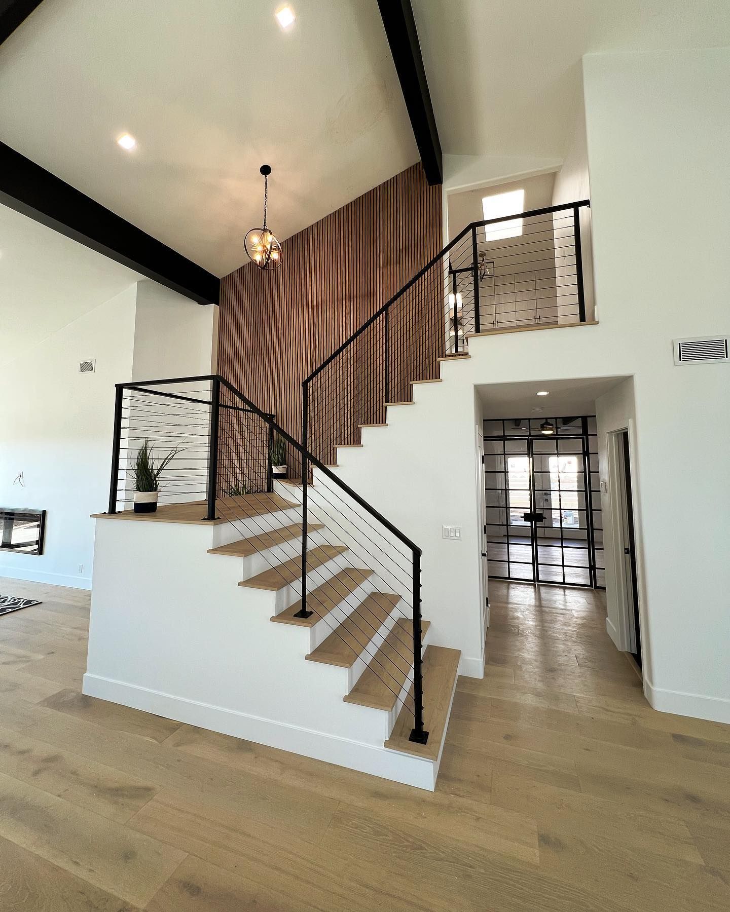 A staircase in a house with a wooden railing