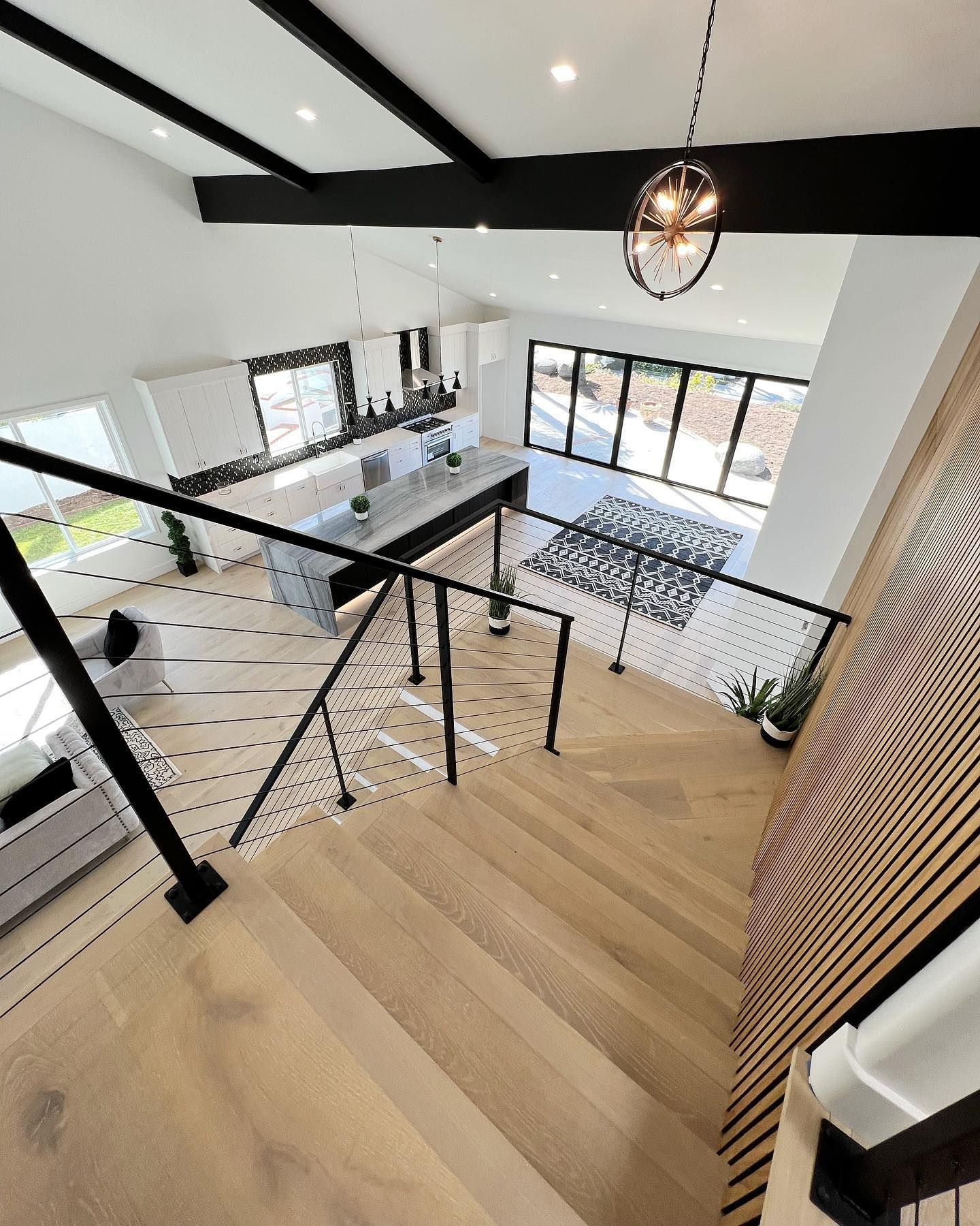 A wooden staircase leading up to a living room in a house.