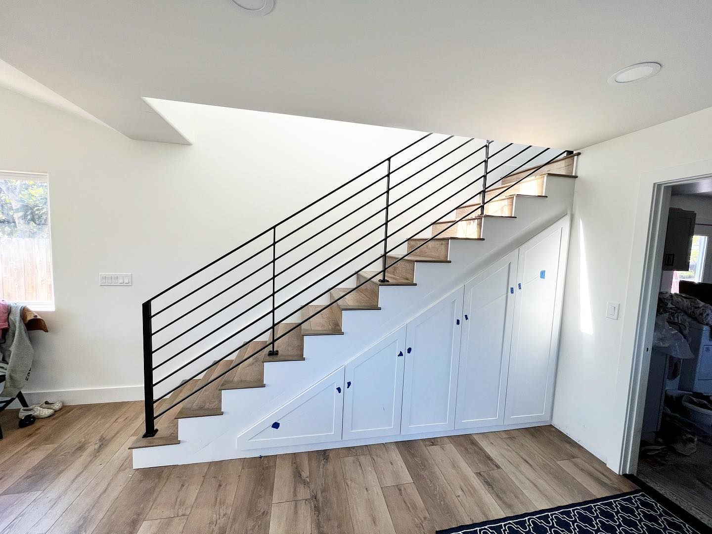 A staircase in a house with a black railing