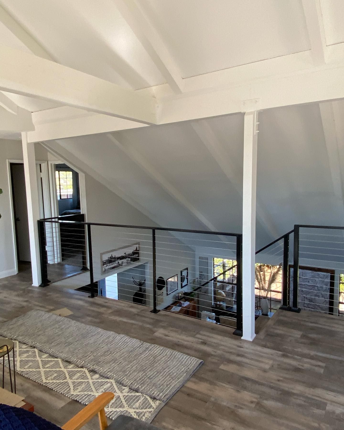 A living room with a staircase leading up to the second floor.