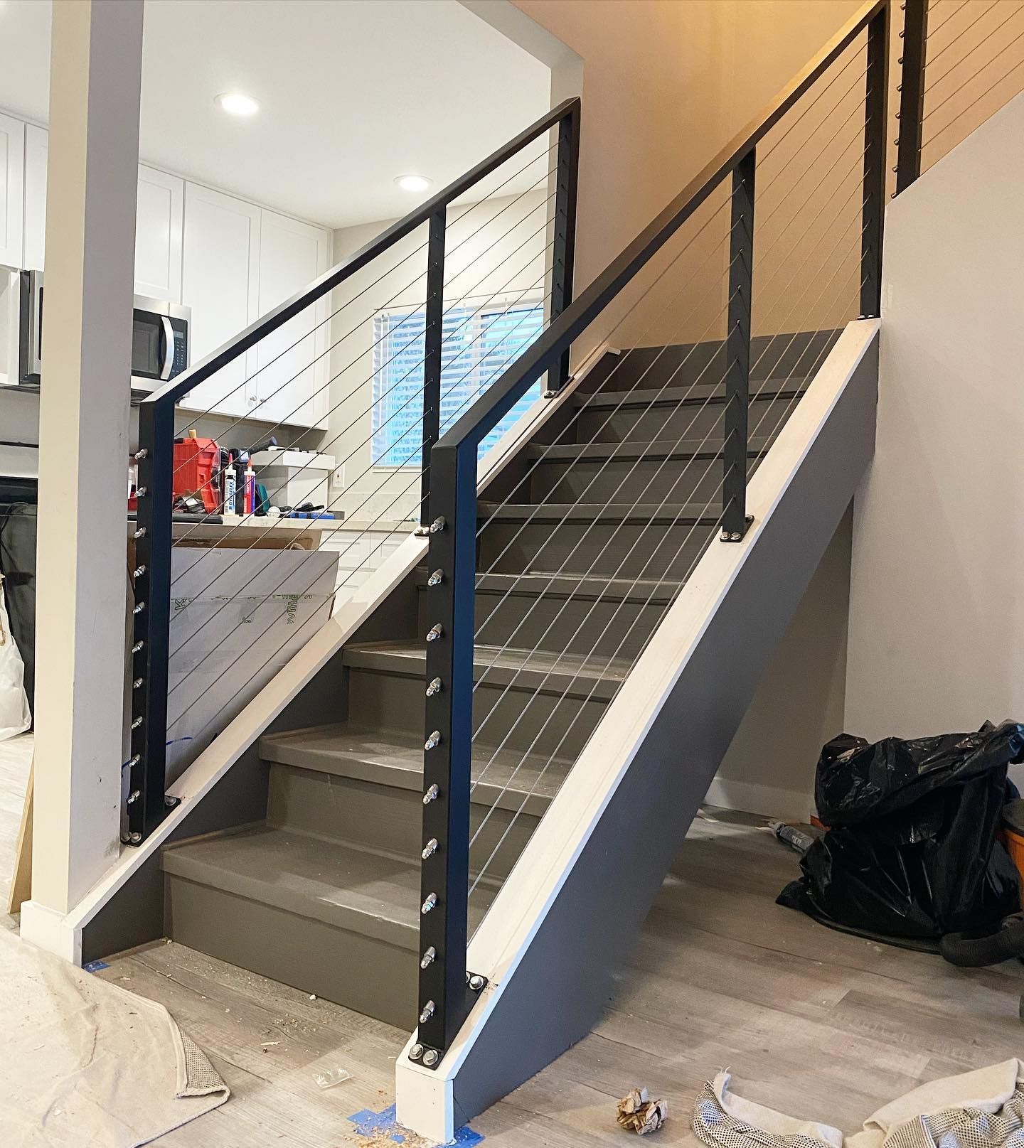A staircase in a house with a black railing