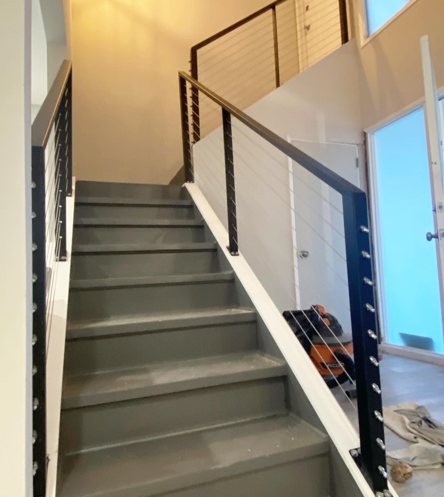 A set of stairs with a black railing