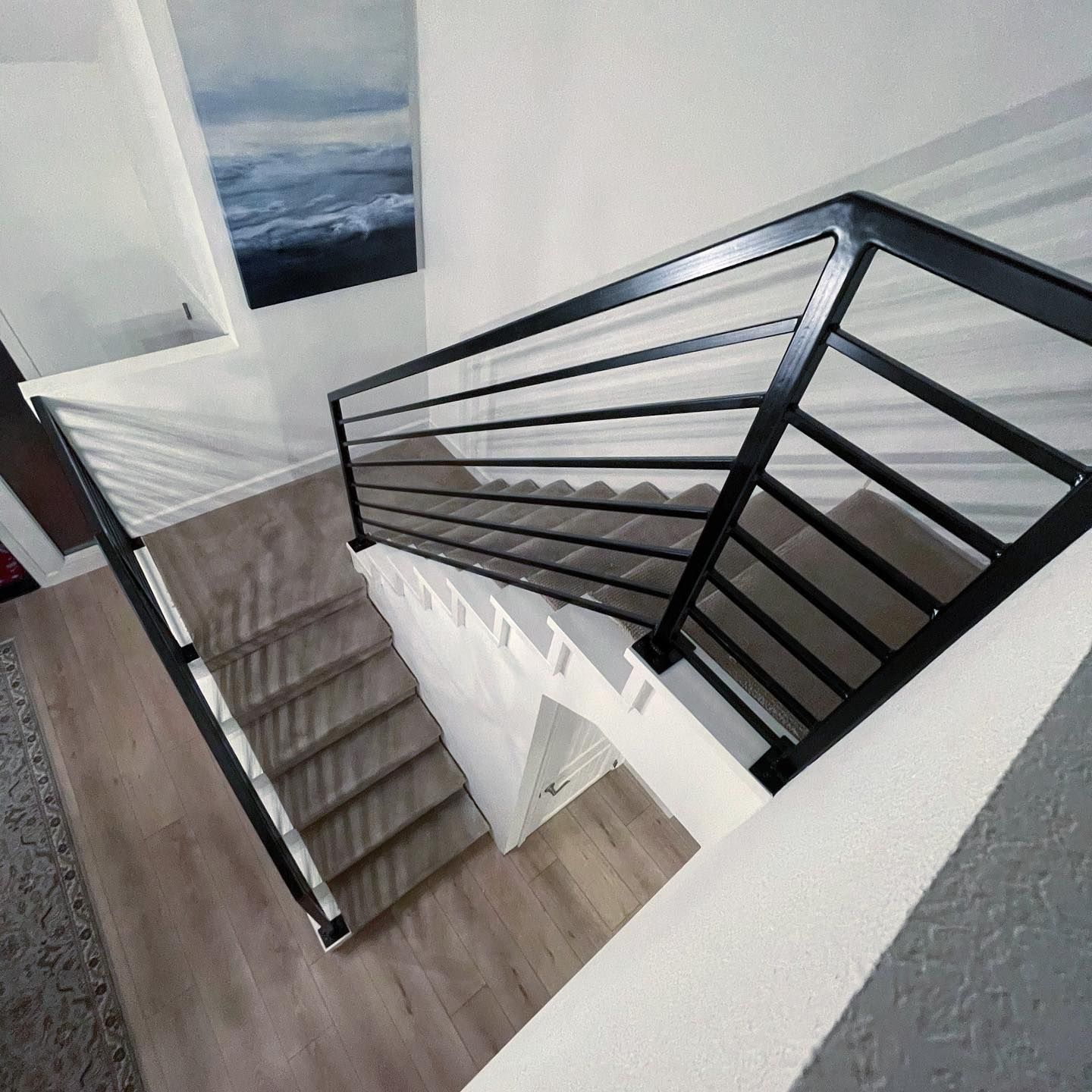 An aerial view of a staircase with a black railing