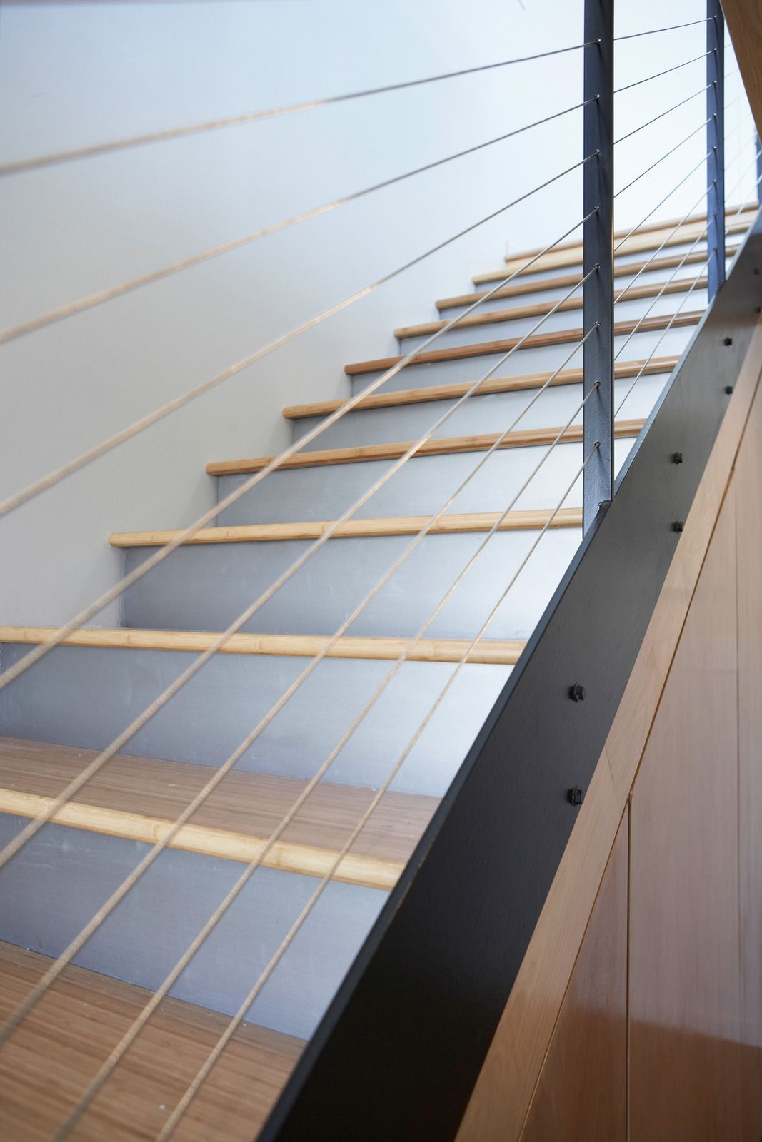 A staircase with a metal railing and wooden steps