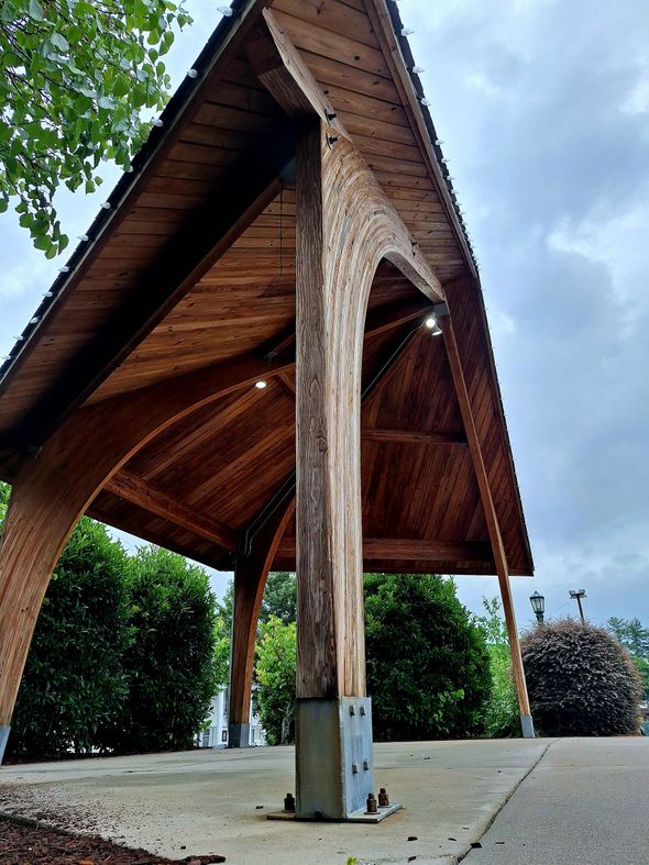 A large wooden structure with a roof and pillars