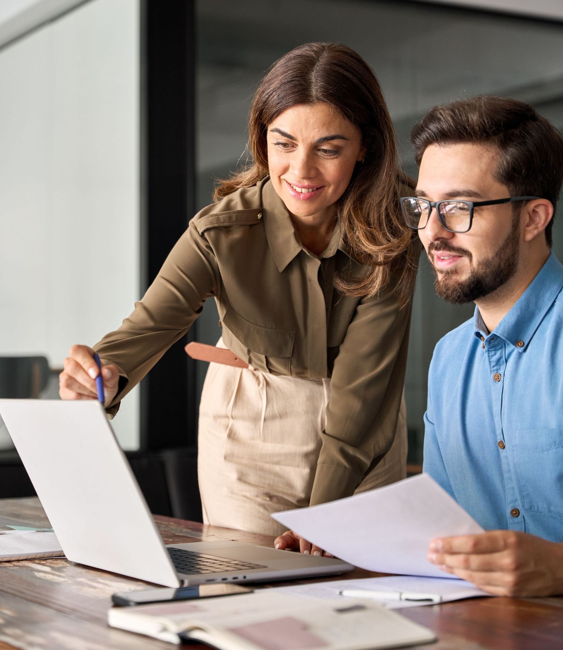 A man in a suit is smiling while talking to another man