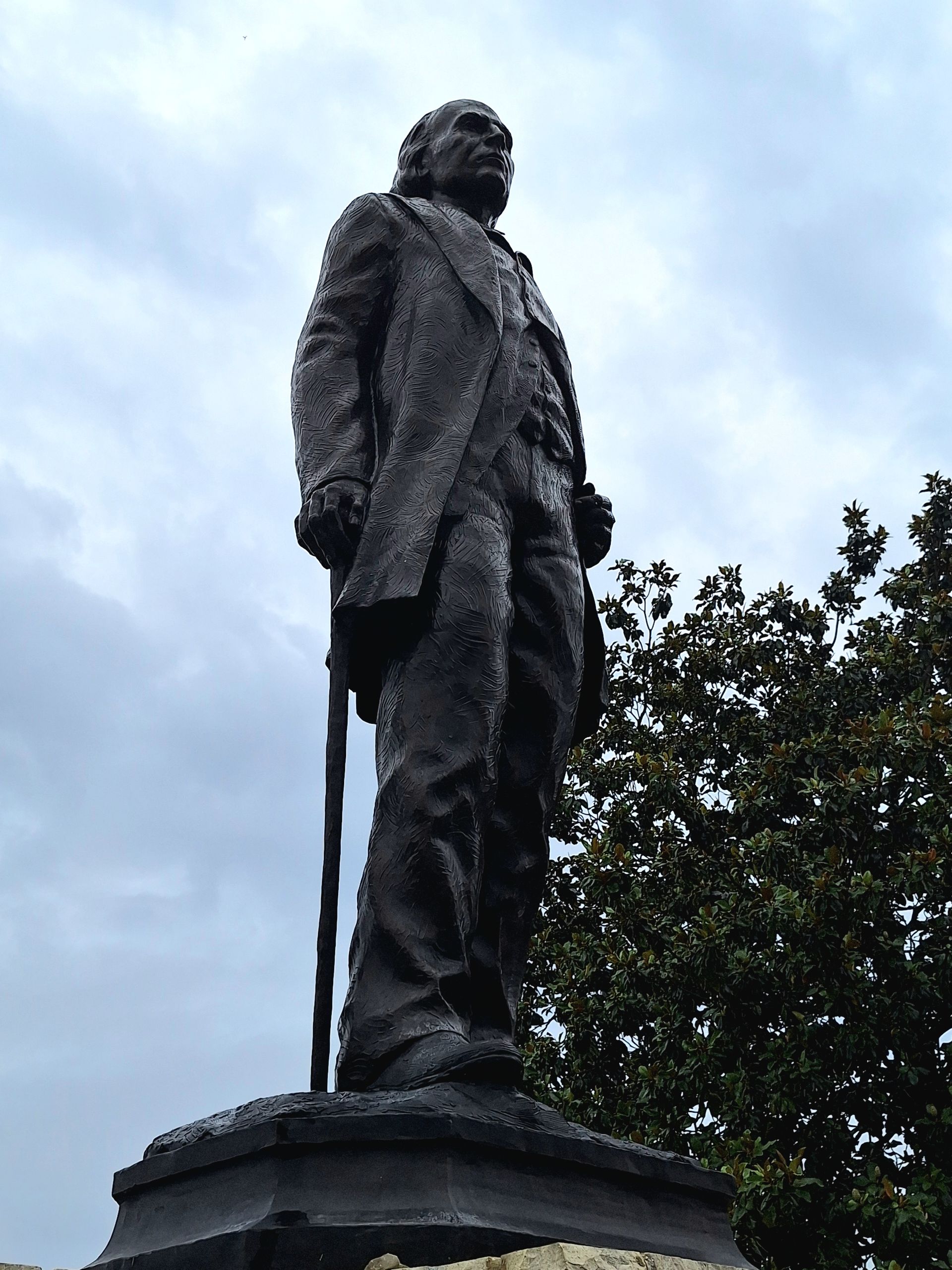 A statue of a man standing with a cane