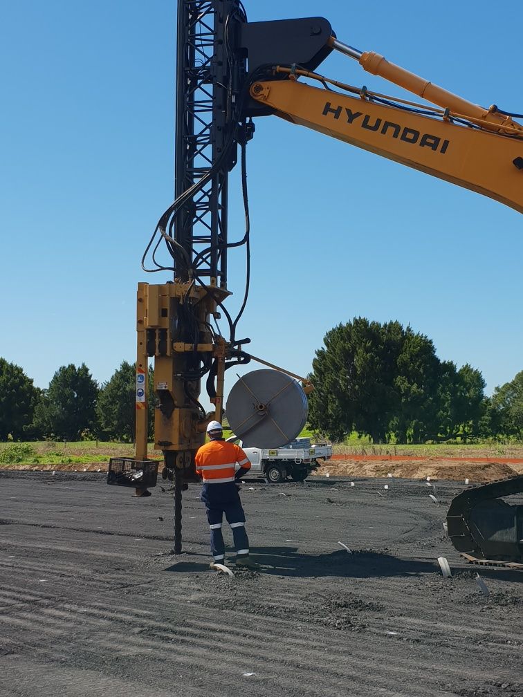 A Man is Standing in Front of a Large Drilling Machine — North Coast Drilling & Wicks in Bangalow, NSW