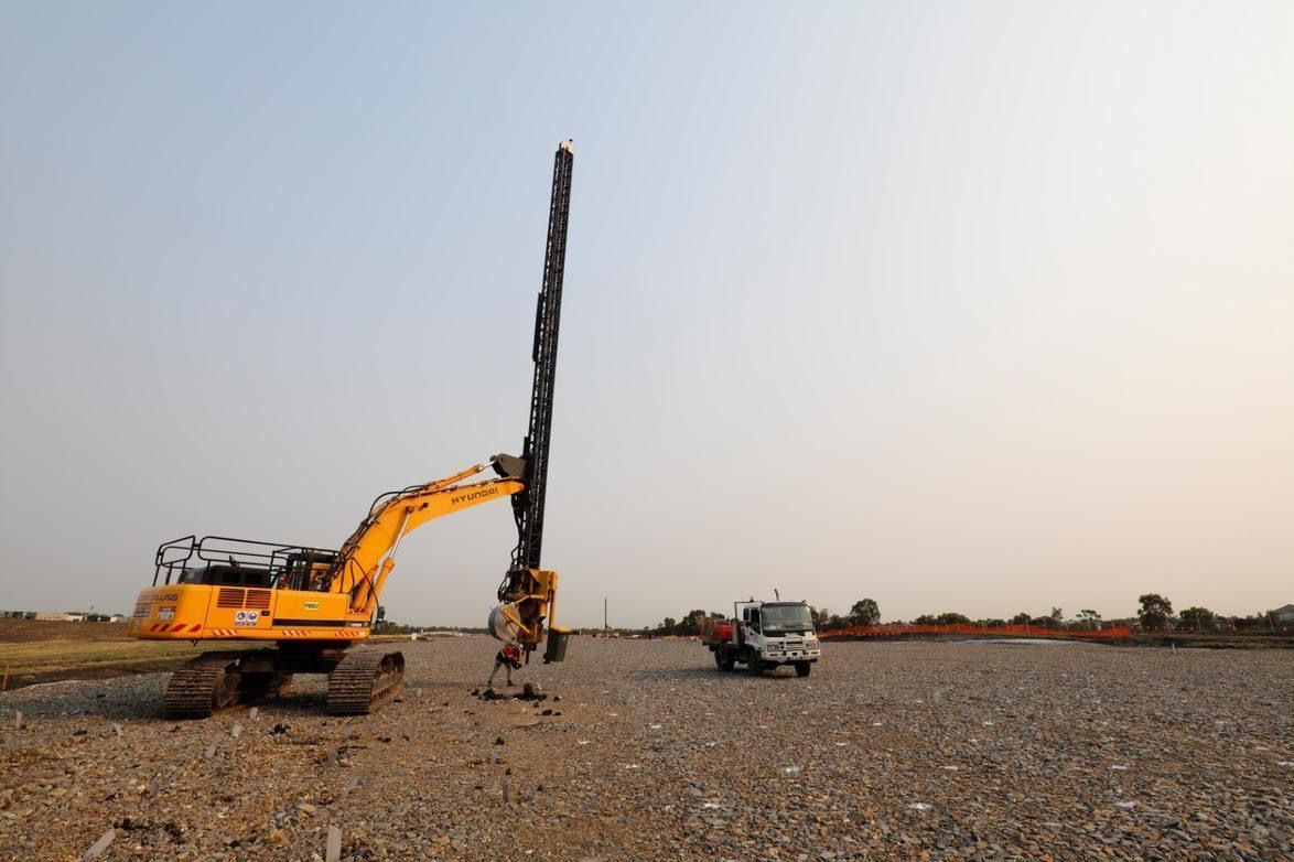 A Large machine with truck and worker are standing on a dirt farm — North Coast Drilling & Wicks in Bangalow, NSW