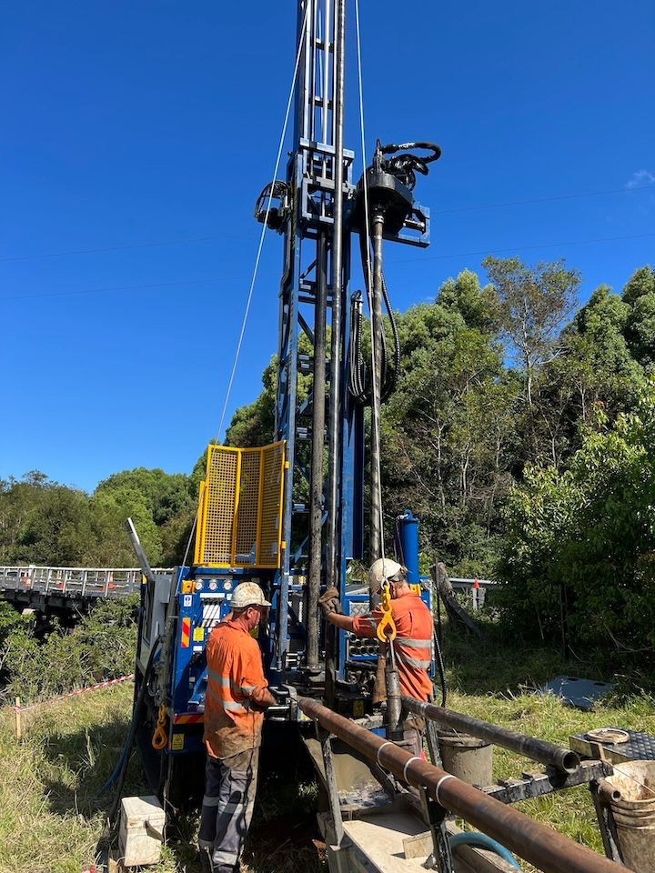 A Drilling Rig is Set Up in a Dirt Field — North Coast Drilling & Wicks in Bangalow, NSW
