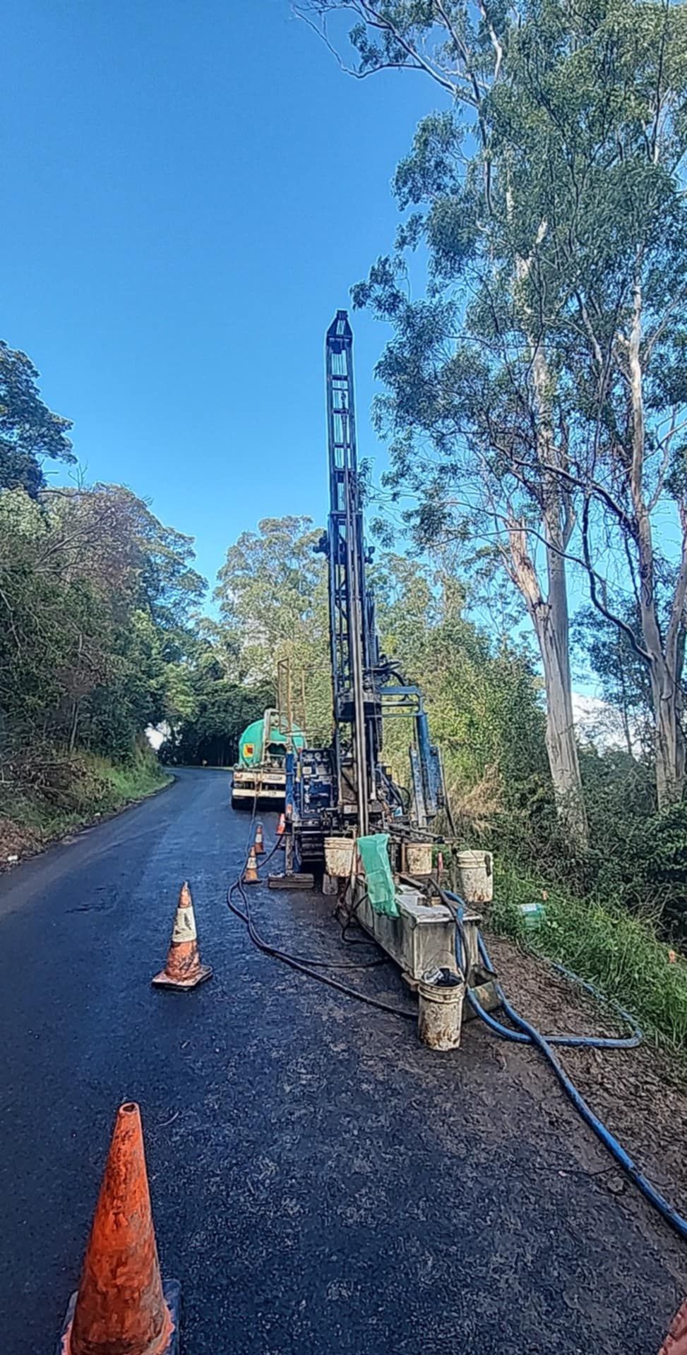 A Large Machine is Parked on the road in forest surrounded by cones — North Coast Drilling & Wicks in Bangalow, NSW