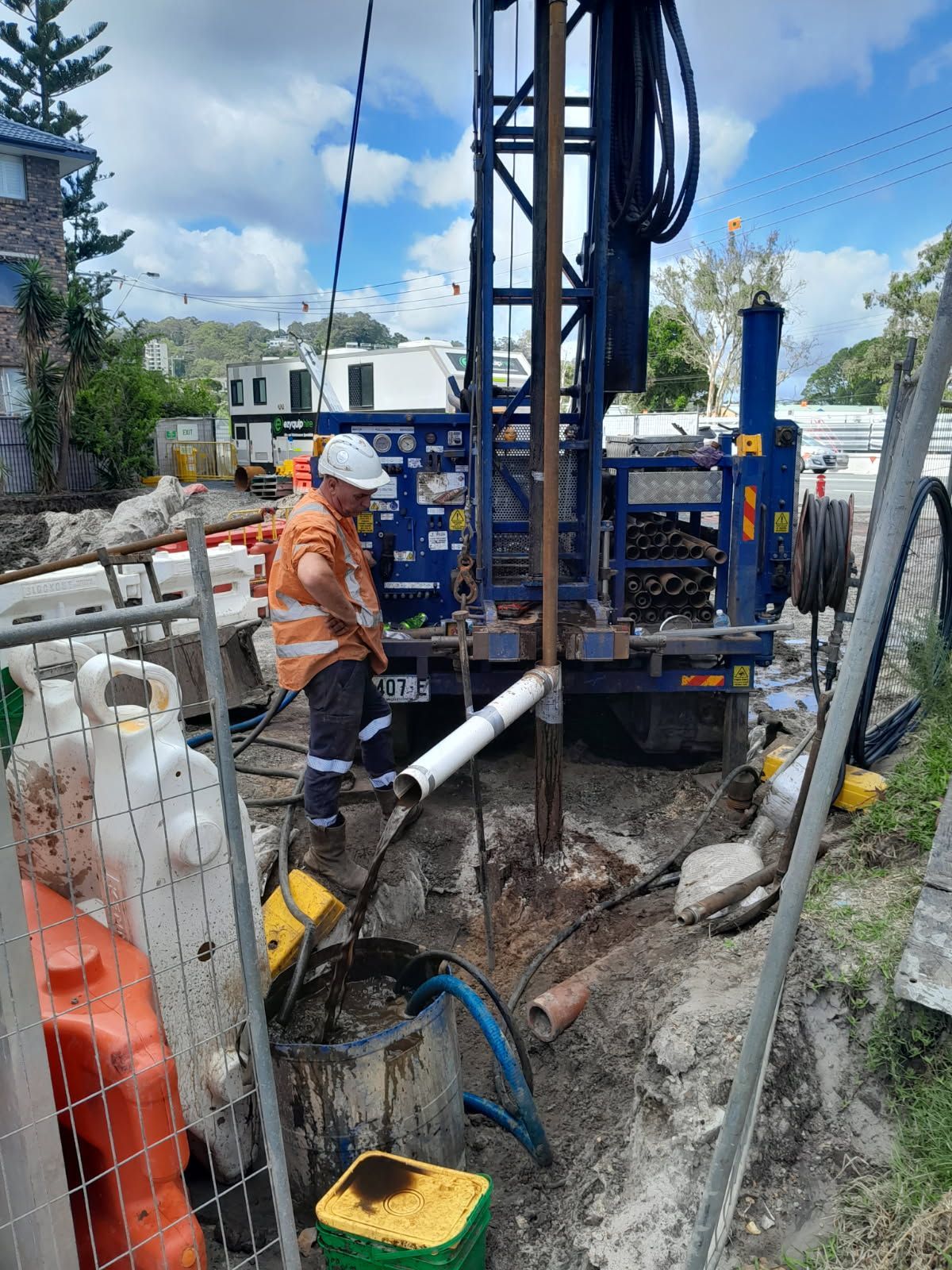 A Construction Worker is standing by large machine on construction site— North Coast Drilling & Wicks in Bangalow, NSW