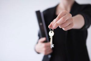 Woman holding Key to home