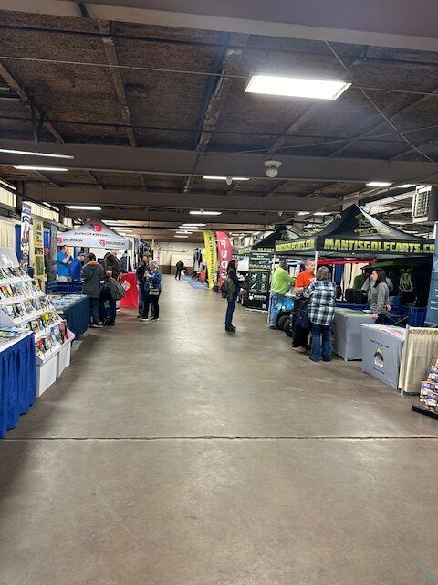 A group of people are standing in a hallway at a convention.