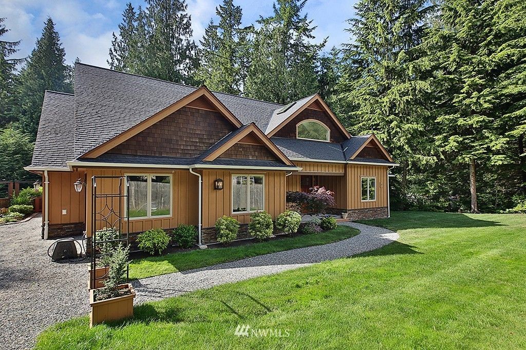 A large house with a lush green lawn in front of it