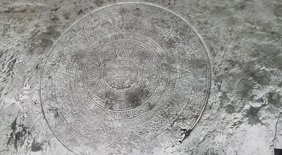 A black and white photo of a circle on a concrete surface.