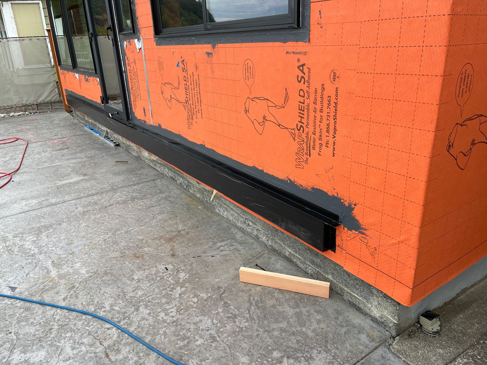 An orange building with a black trim is being built.